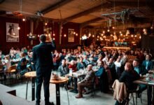 speaker engaging audience in packed venue