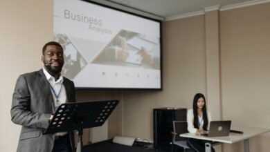 a man speaking on a conference