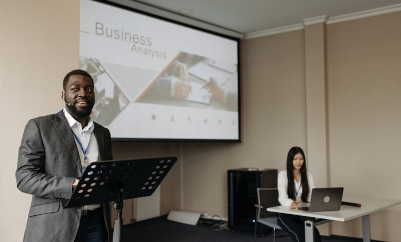 a man speaking on a conference