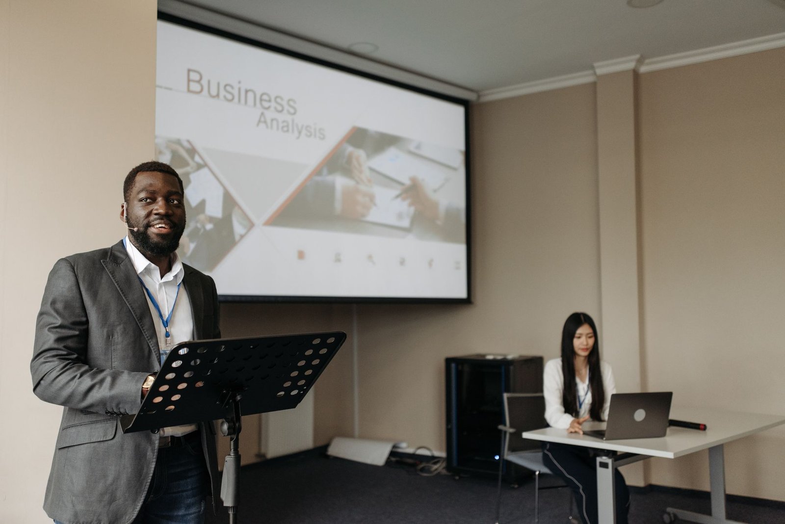 a man speaking on a conference