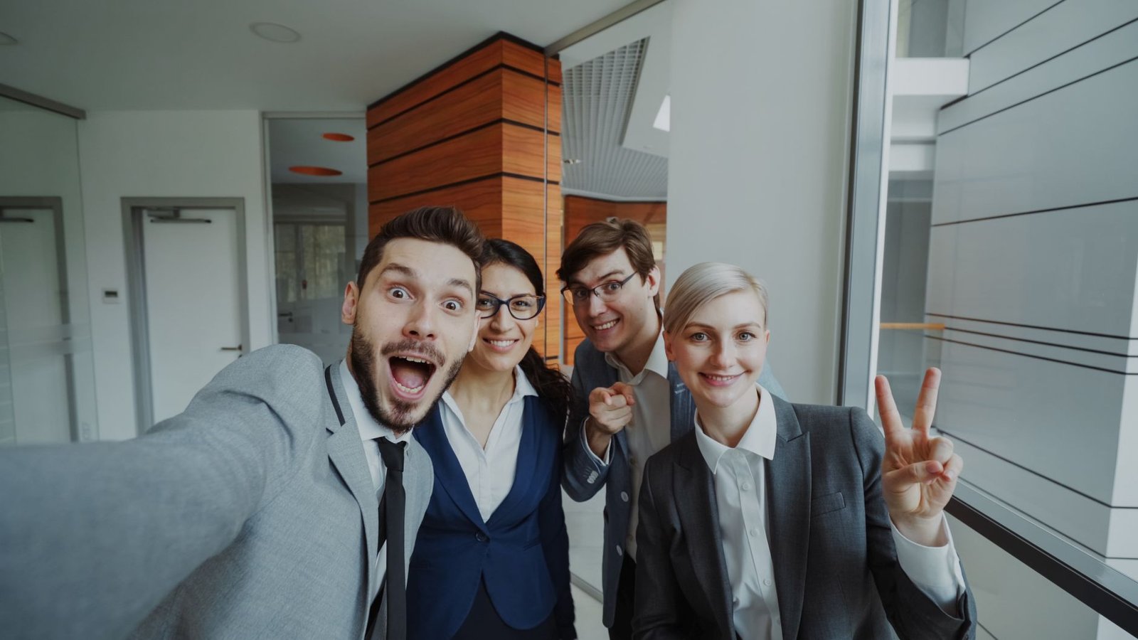 business team celebrating in office selfie
