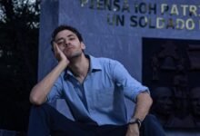 fashionable man sitting on steps in a park