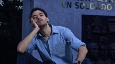 fashionable man sitting on steps in a park