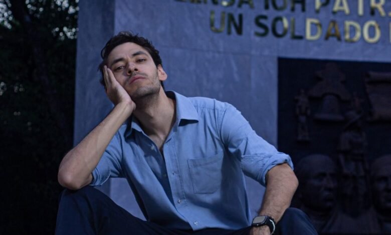fashionable man sitting on steps in a park