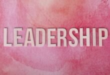 pink background with leadership text in bold letters
