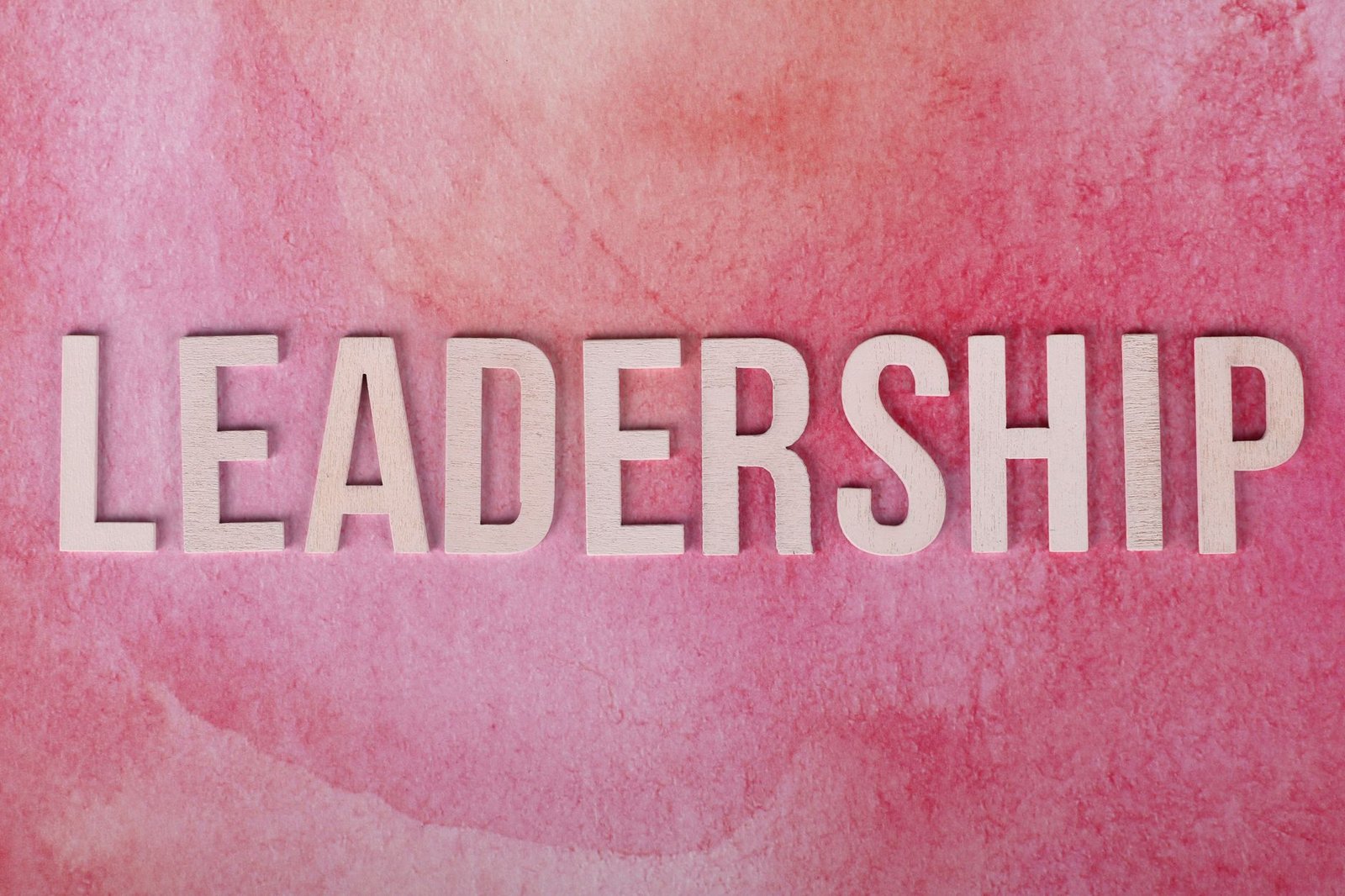 pink background with leadership text in bold letters