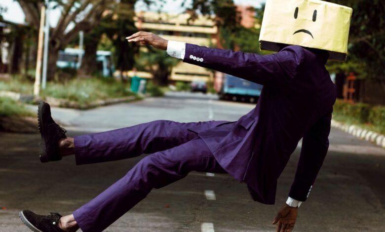 model in purple suit with unhappy face cardboard box