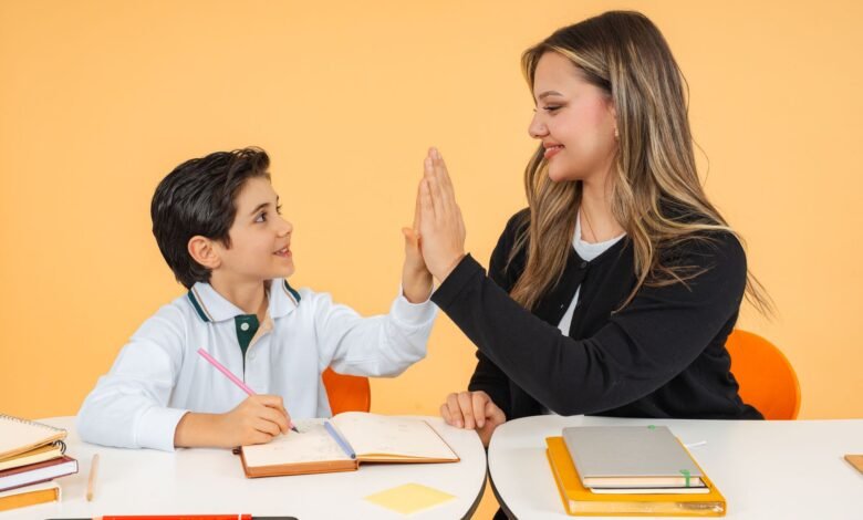 teacher and student high five in classroom setting