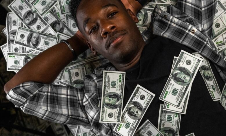 man lying down with money
