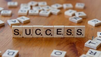 success concept with letter tiles on wooden surface