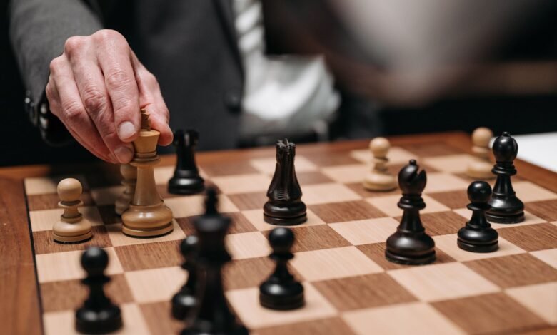 hand holding a chess piece