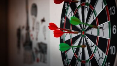 close up photo of dart pins on dartboard