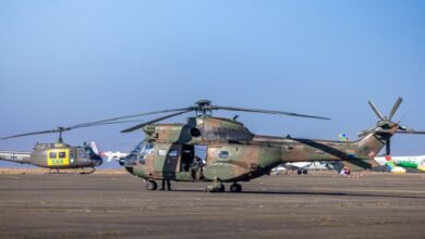 military helicopter on runway with crew