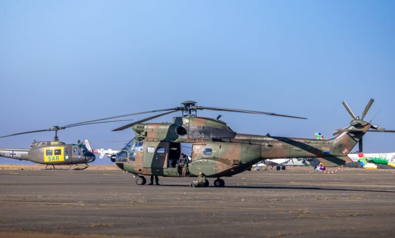 military helicopter on runway with crew