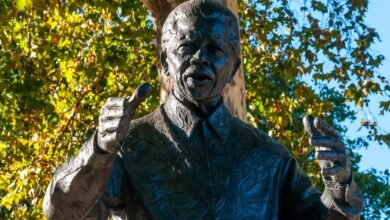 bronze statue of a historic figure in park setting