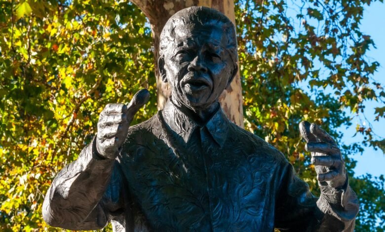 bronze statue of a historic figure in park setting
