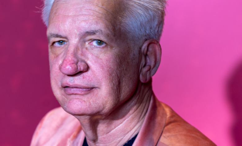 portrait of senior man in pink jacket