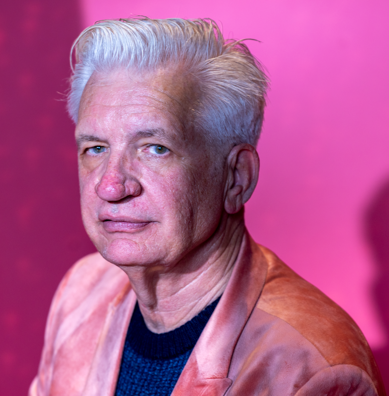 portrait of senior man in pink jacket