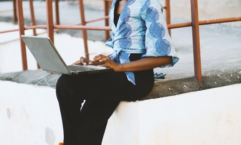 woman sitting on white concrete edge with railing