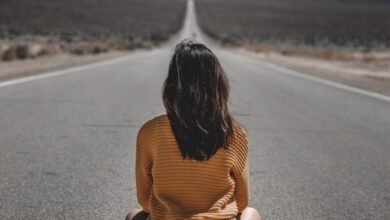 woman sitting on road