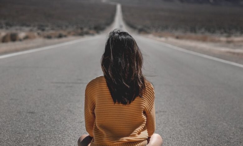 woman sitting on road