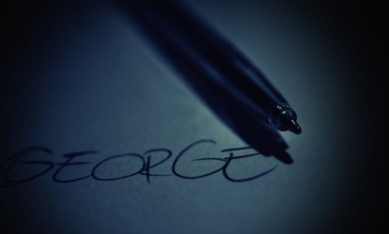 black pen on top of white paper with george text