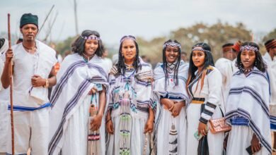 women and man standing in traditional clothing