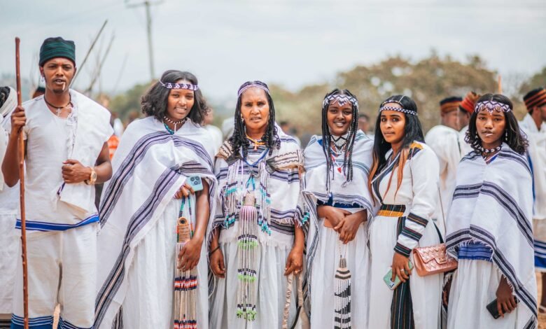 women and man standing in traditional clothing