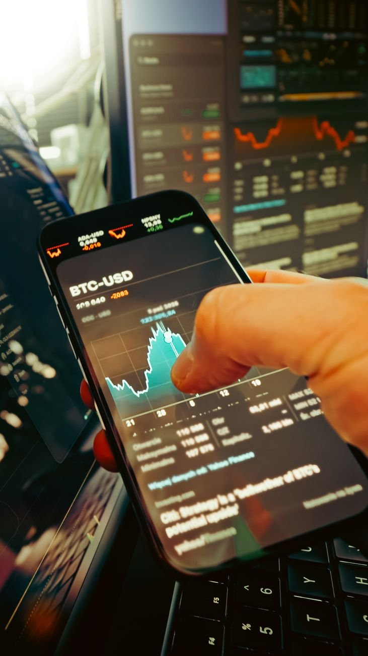 hand holding smartphone with cryptocurrency chart