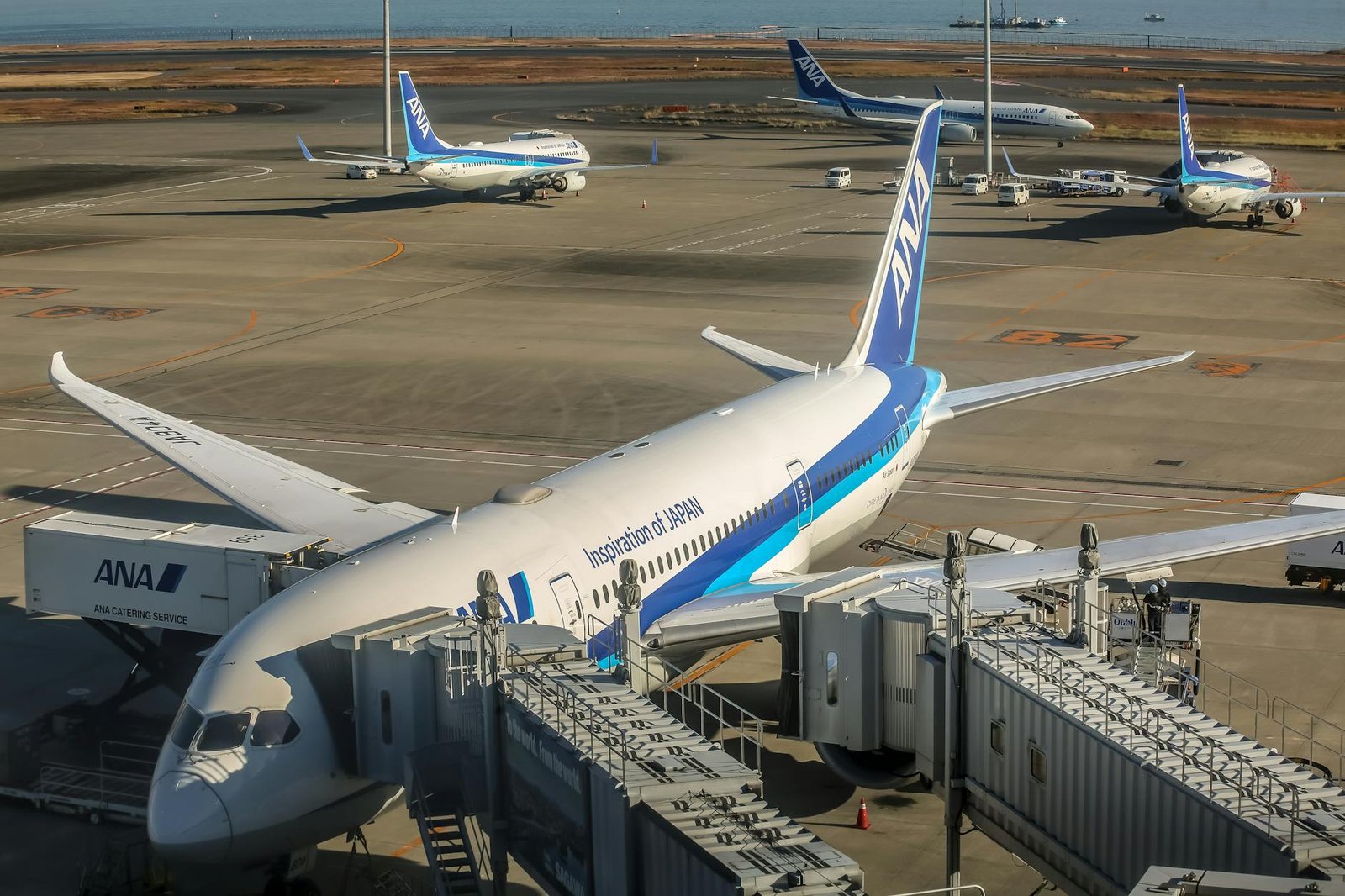 passenger planes at airport terminal with jet bridge