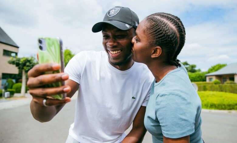 happy couple taking a selfie outdoors in brussels