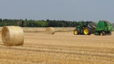 tractor baling straw in a field in neuss