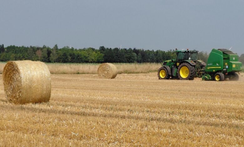 tractor baling straw in a field in neuss