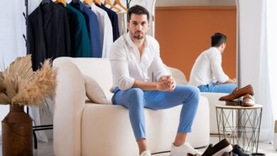 stylish man sitting in modern fashion showroom