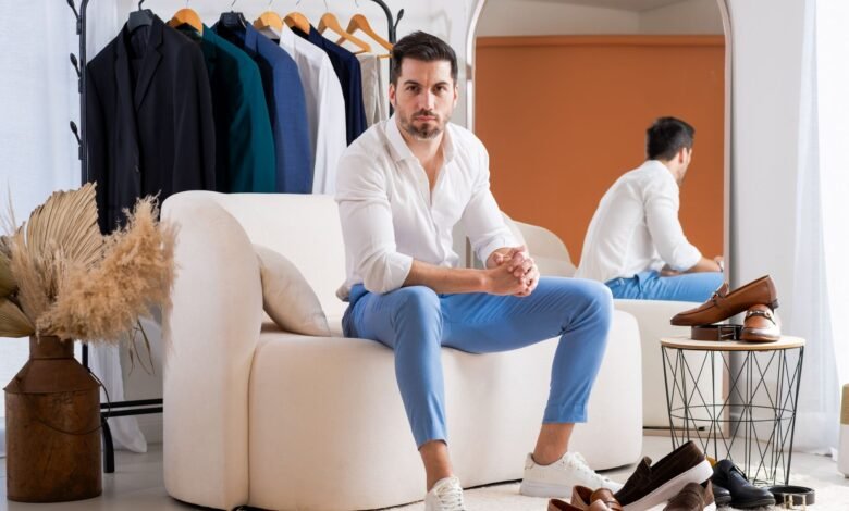 stylish man sitting in modern fashion showroom