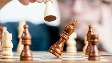 man holding chess piece