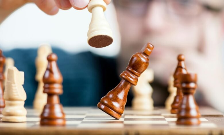 man holding chess piece