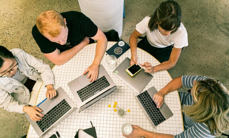 four people using laptop computers and smartphone