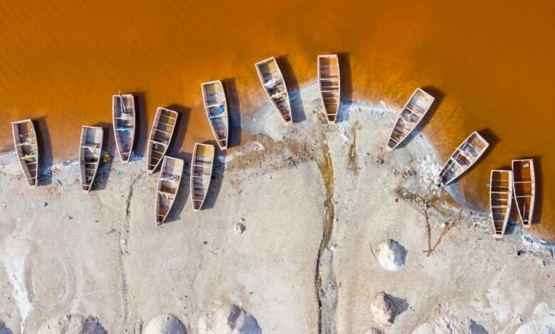 shabby boats moored on white beach near yellow water river