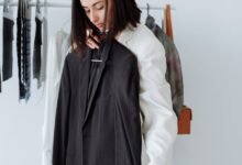 a woman holding a black coat