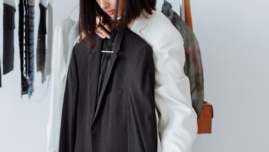 a woman holding a black coat