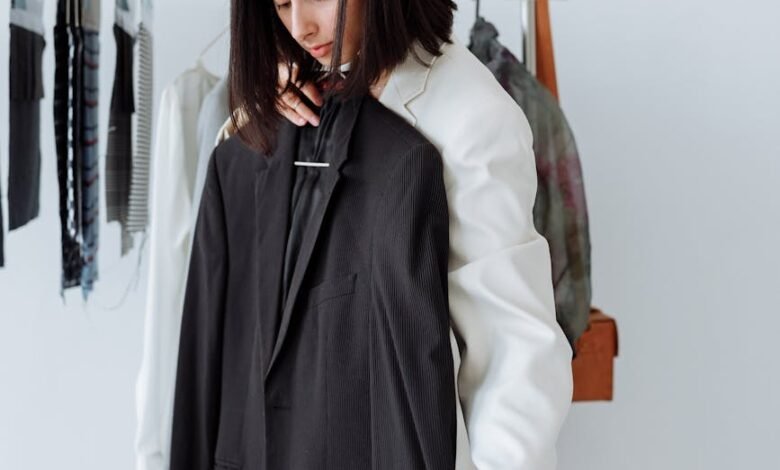 a woman holding a black coat