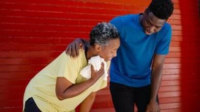 man standing beside a tired elderly woman