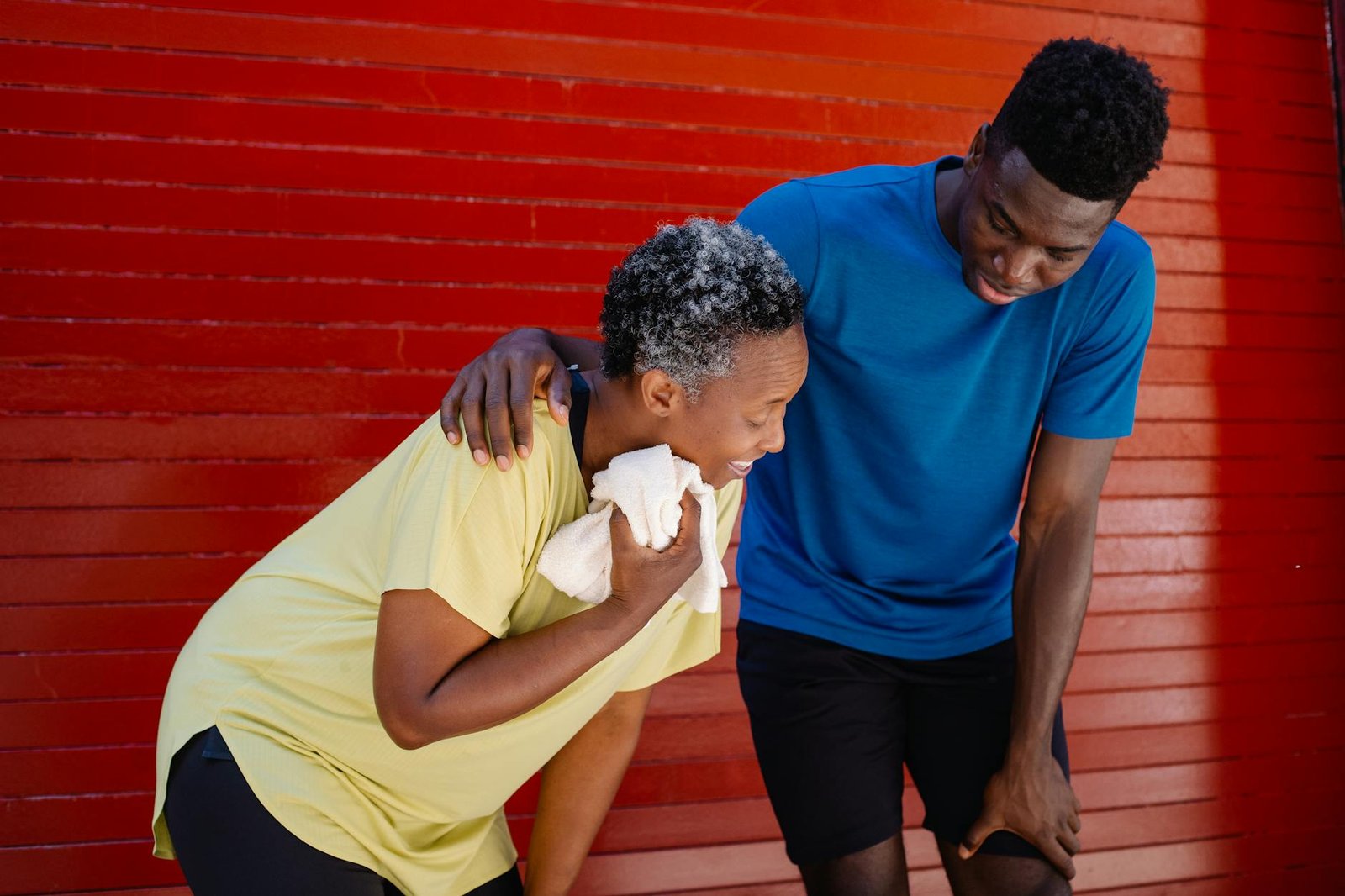 man standing beside a tired elderly woman