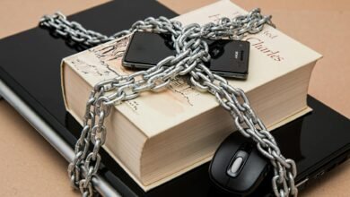 black android smartphone on top of white book