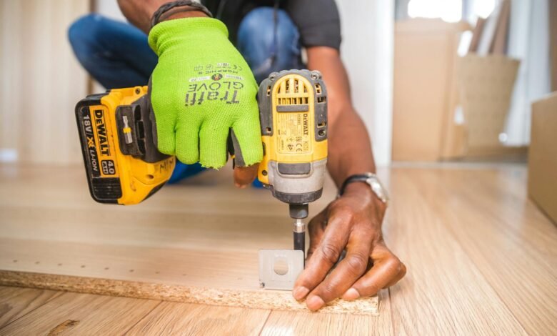 person using dewalt cordless impact driver on brown board