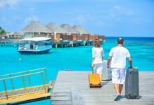 man and woman walks on dock