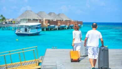 man and woman walks on dock