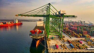 drone shot of a docked cargo ship at a port