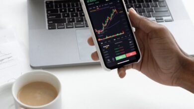 person holding mug and mobile phone